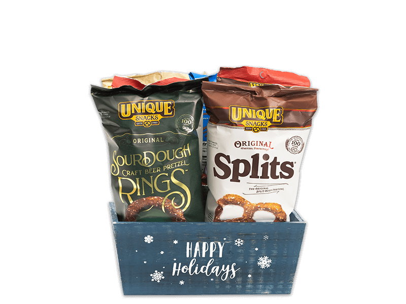 Blue Happy Holiday dark blue box with white snowflakes all over the box and the words happy holidays written in white cursive filled with various Unique Snacks products