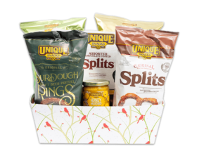 Cardinal Tray with white background and cardinals in tree branches, filled with various Unique Snacks products